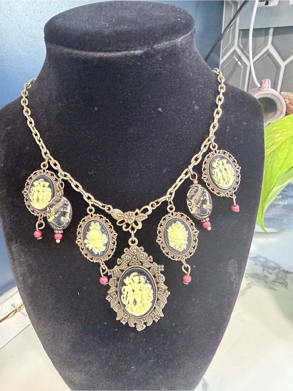 Vintage-Inspired Gold-Tone Cameo Necklace with Yellow Accents.